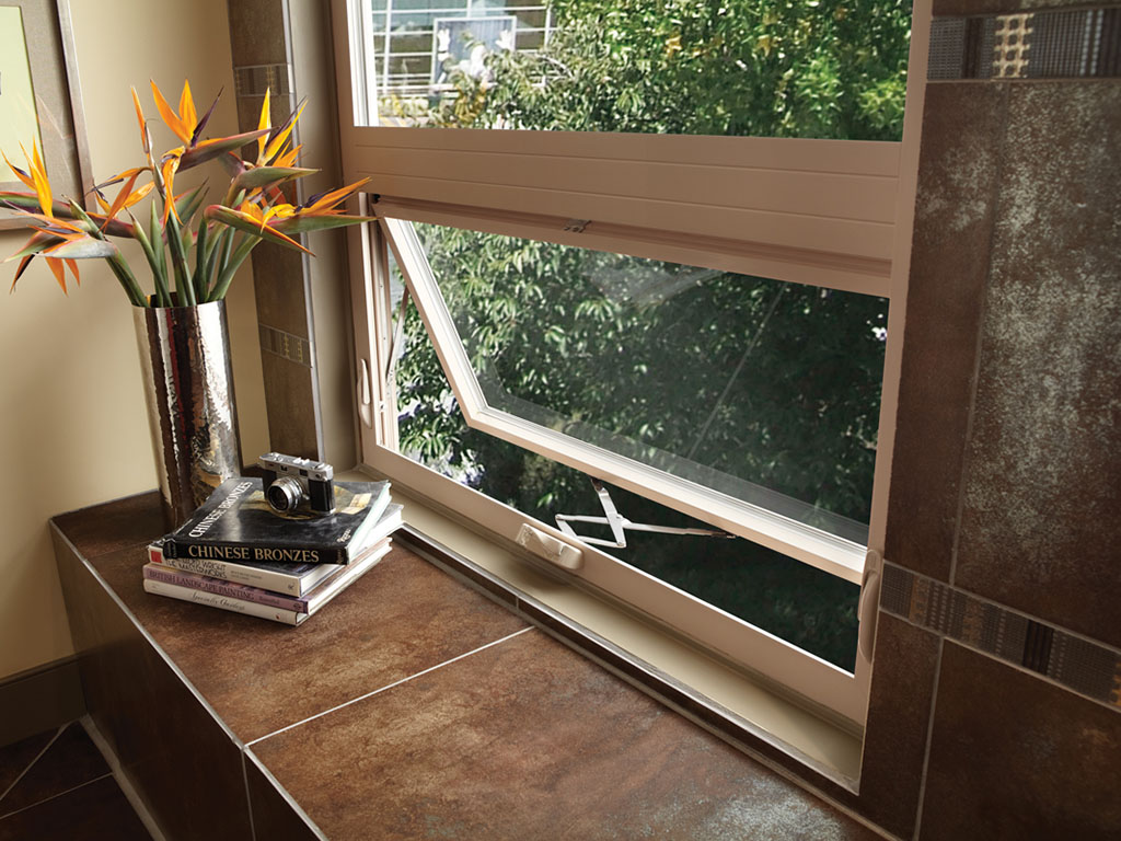 An open casement egress window above a finished interior bench