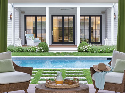 Home exterior with Marvin windows overlooking a pool