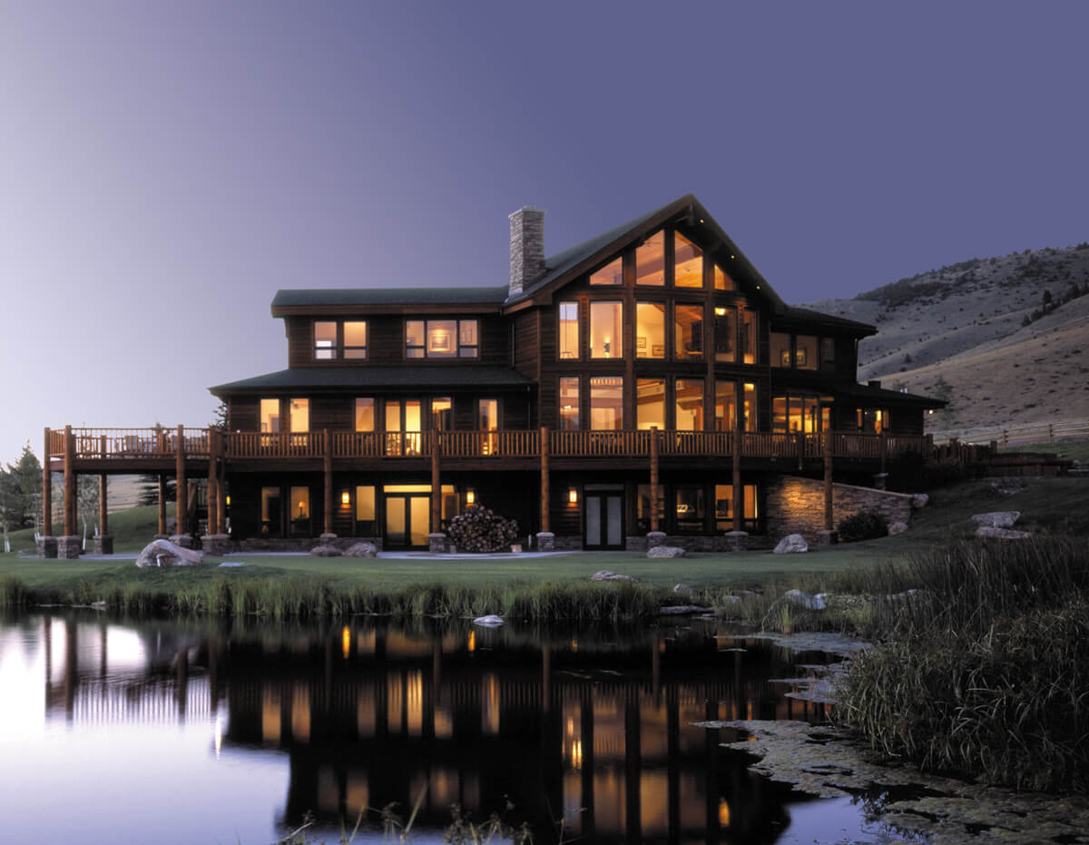A large multi-family building at dusk with new windows and doors