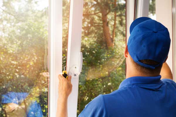 A Lifetime installer carefully fitting and sealing a replacement window