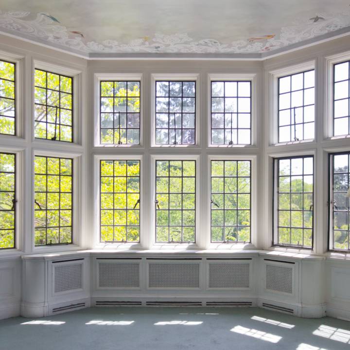 Large white bay window overlooking trees